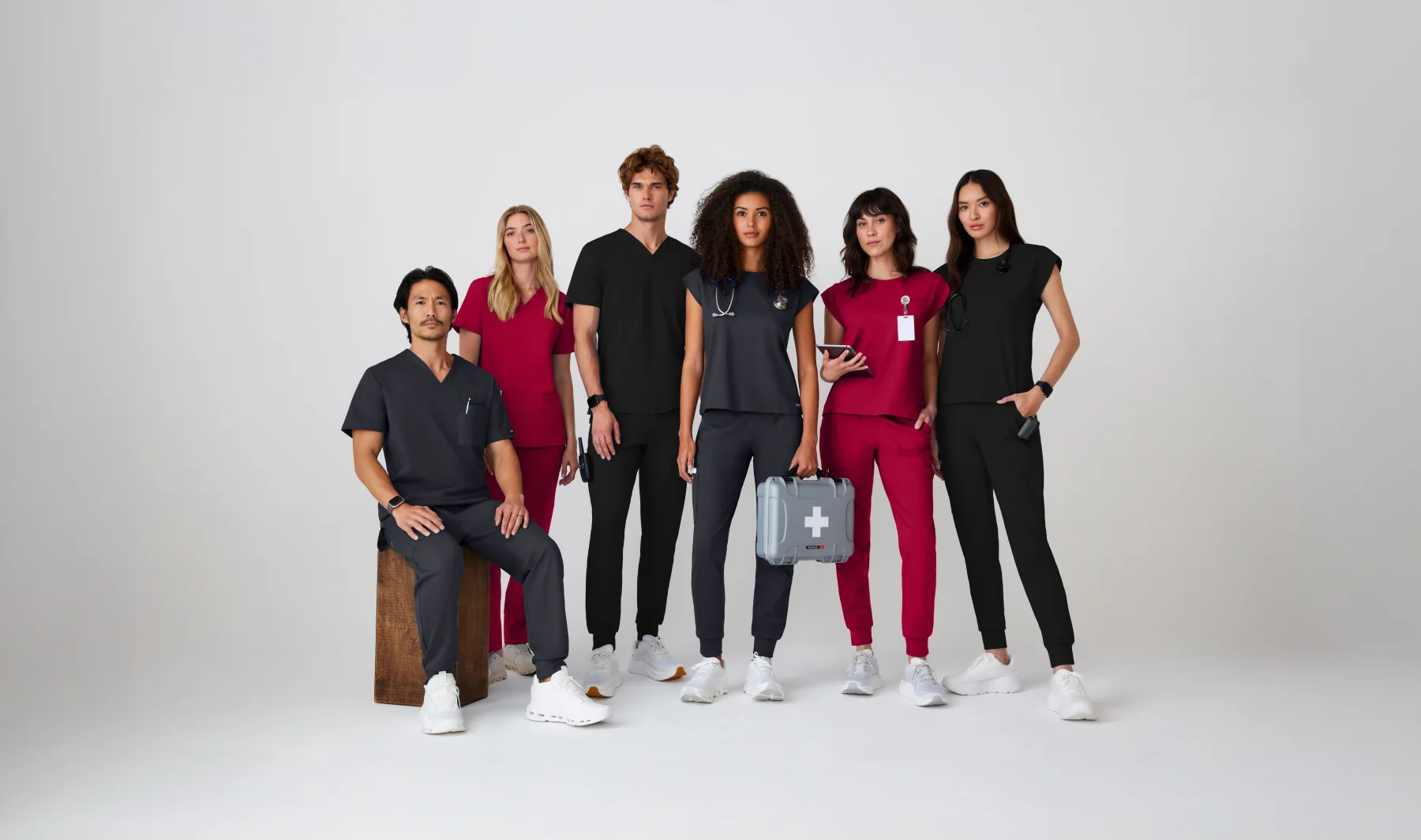 Group of healthcare professionals wearing various colored scrubs, representing Scrubs By Design's diverse selection