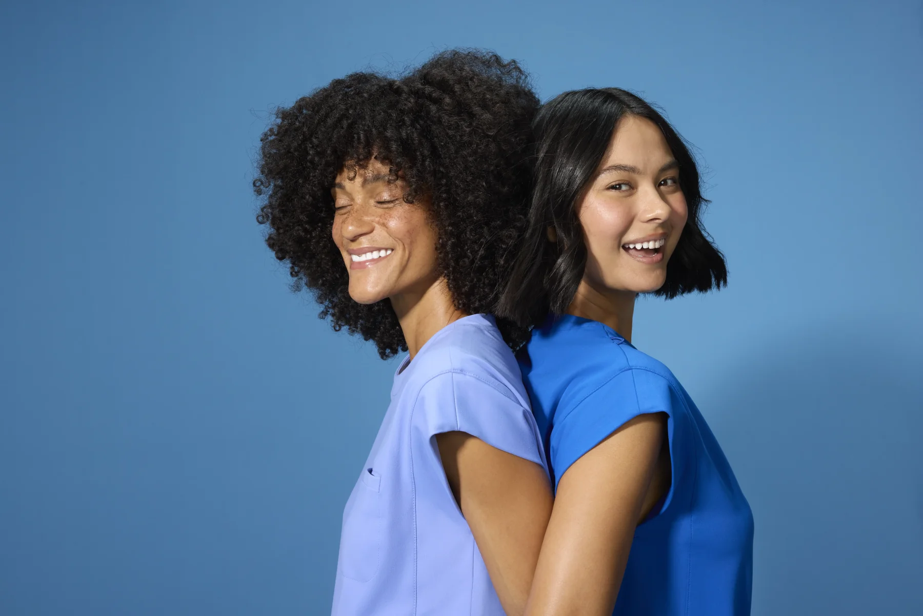 Smiling women in blue scrubs, symbolizing comfort and style from Scrubs By Design